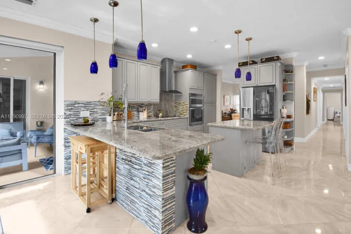 Full impact doors and quartz countertops leading to the secondary bedroom wing