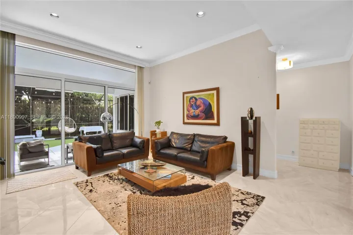 Full impact doors. Spacious living room with natural light and open layout