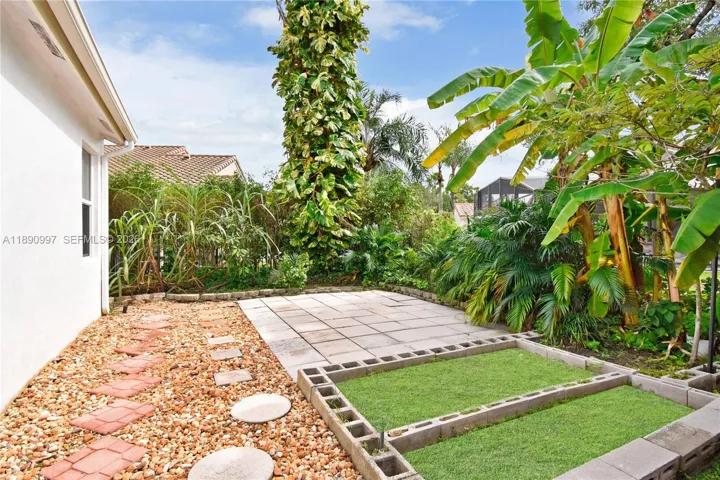 Backyard currently used as a herb garden with mature fruit trees. Connects to the cabana bath.