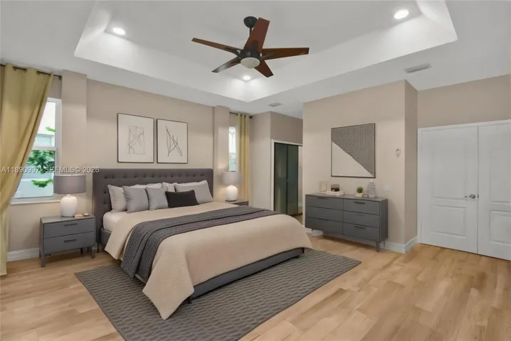Virtual staging. Spacious primary bedroom with views of the patio