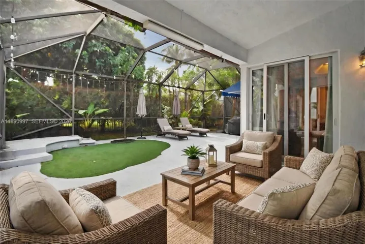 Virtual staging. Covered sitting area within screened patio enclosure