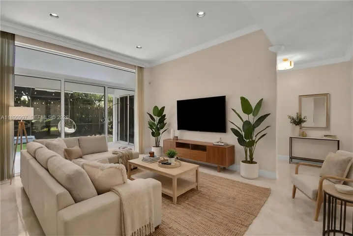 Virtual staging. Full impact doors opening to serene patio views