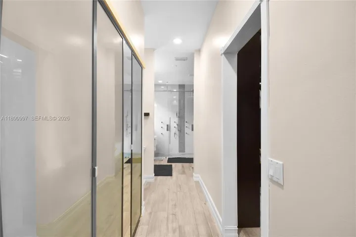 Custom His & Hers closets, a makeup vanity area leading to the primary bathroom