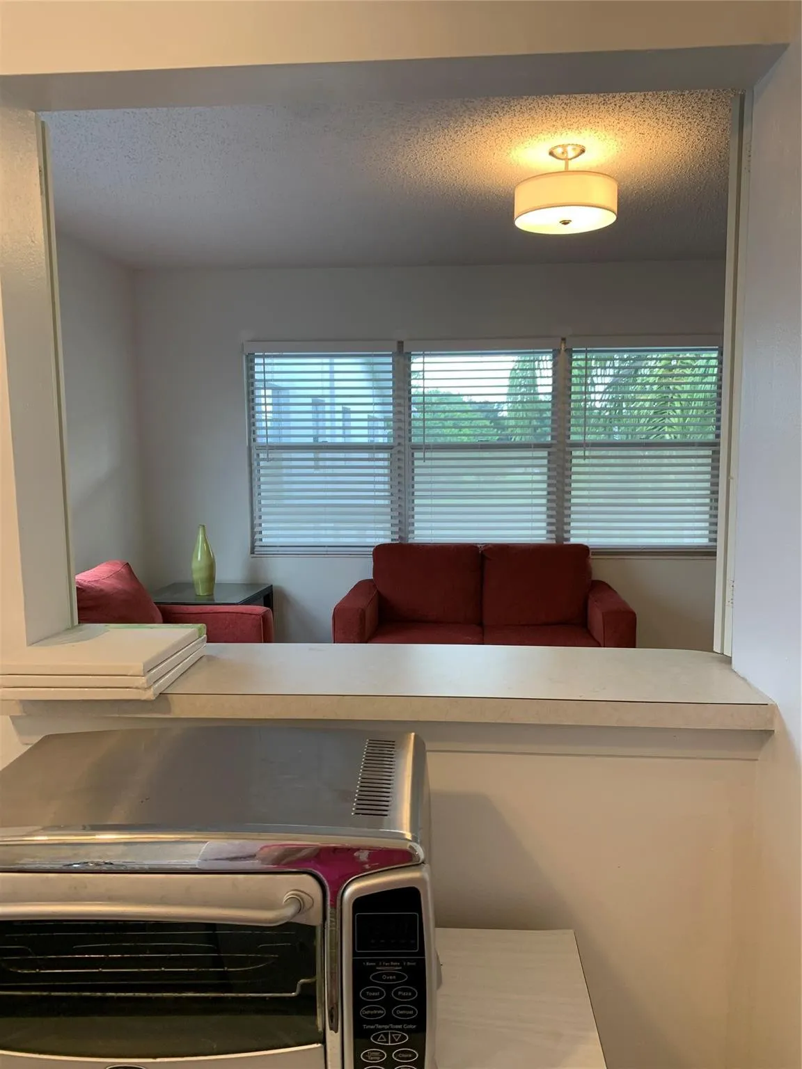 Service Widow in Kitchen wall, looking through to Living room.