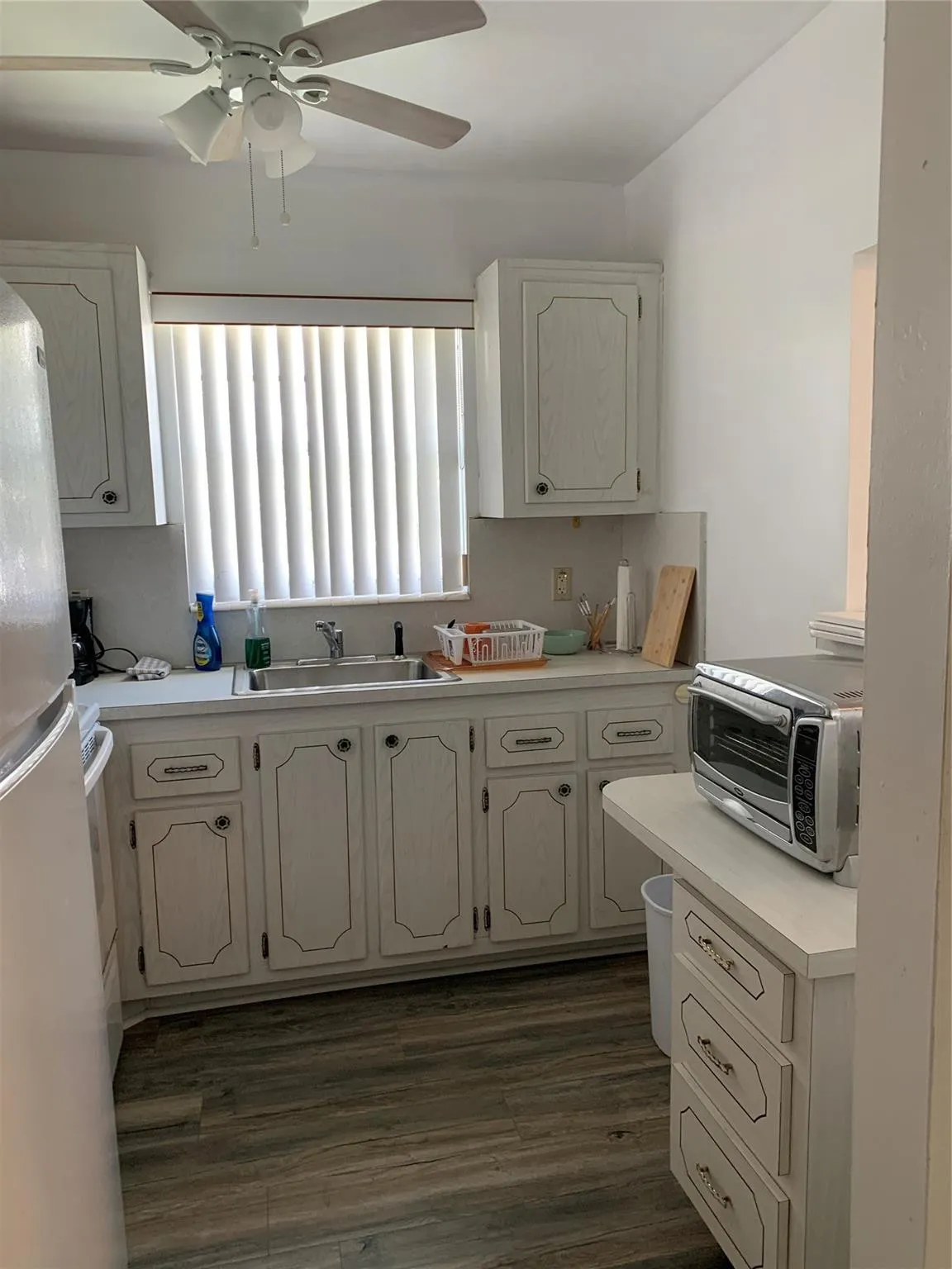 Showing Newly painted kitchen with ceiling Fan.