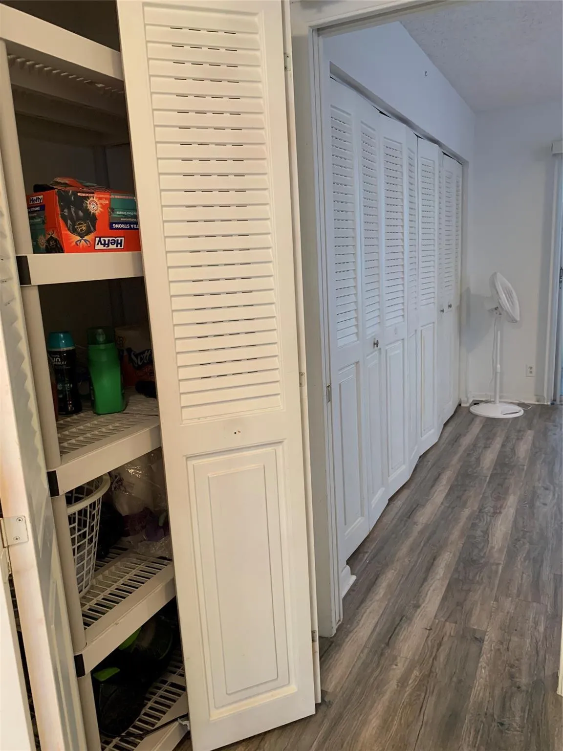 Utility Cabinet in hall way across from Guest Bathroom.