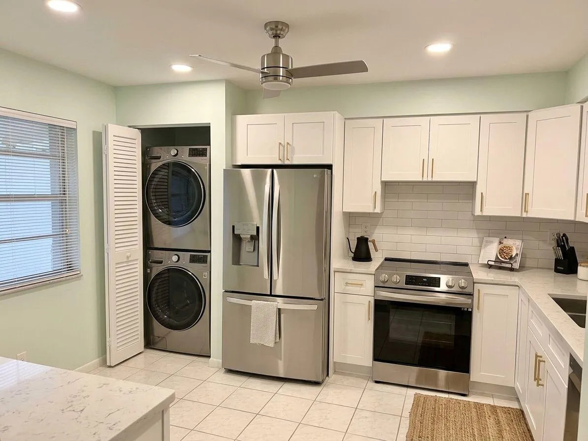 Digitally enhanced photo of Kitchen. Virtually staged cabinets, countertop and appliances.