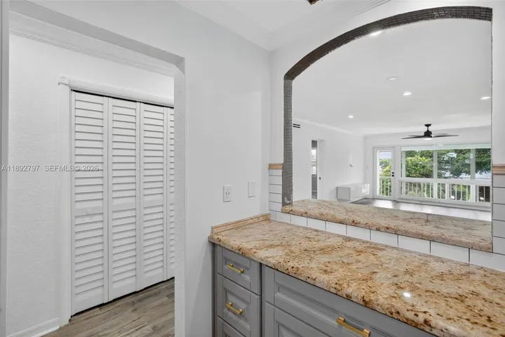 Open Concept Kitchen w/ newer stainless appliances, granite counter, updated cabinets and subway backsplash.