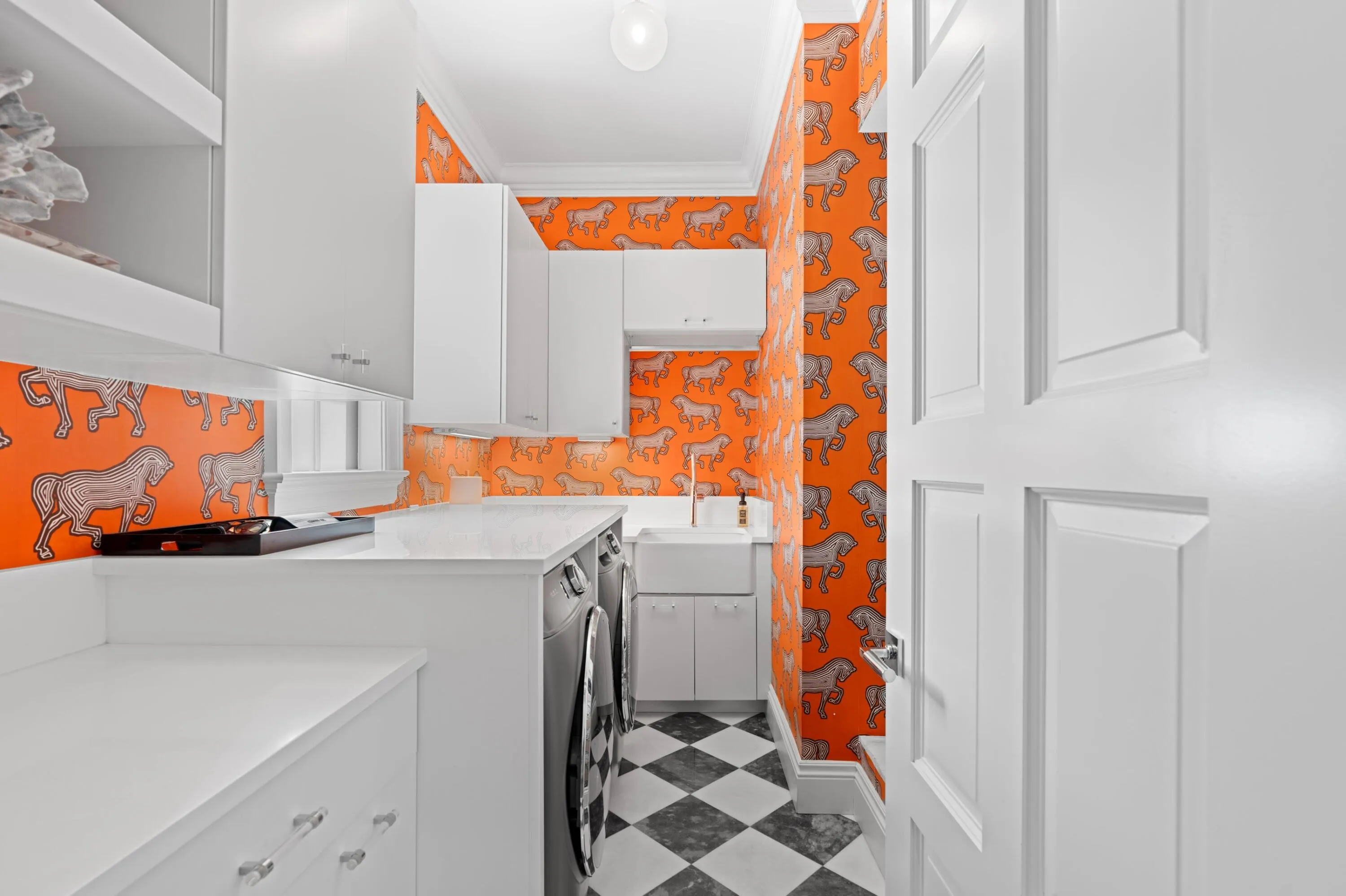 Schumacher wall paper adds a touch of glamour to this utility room