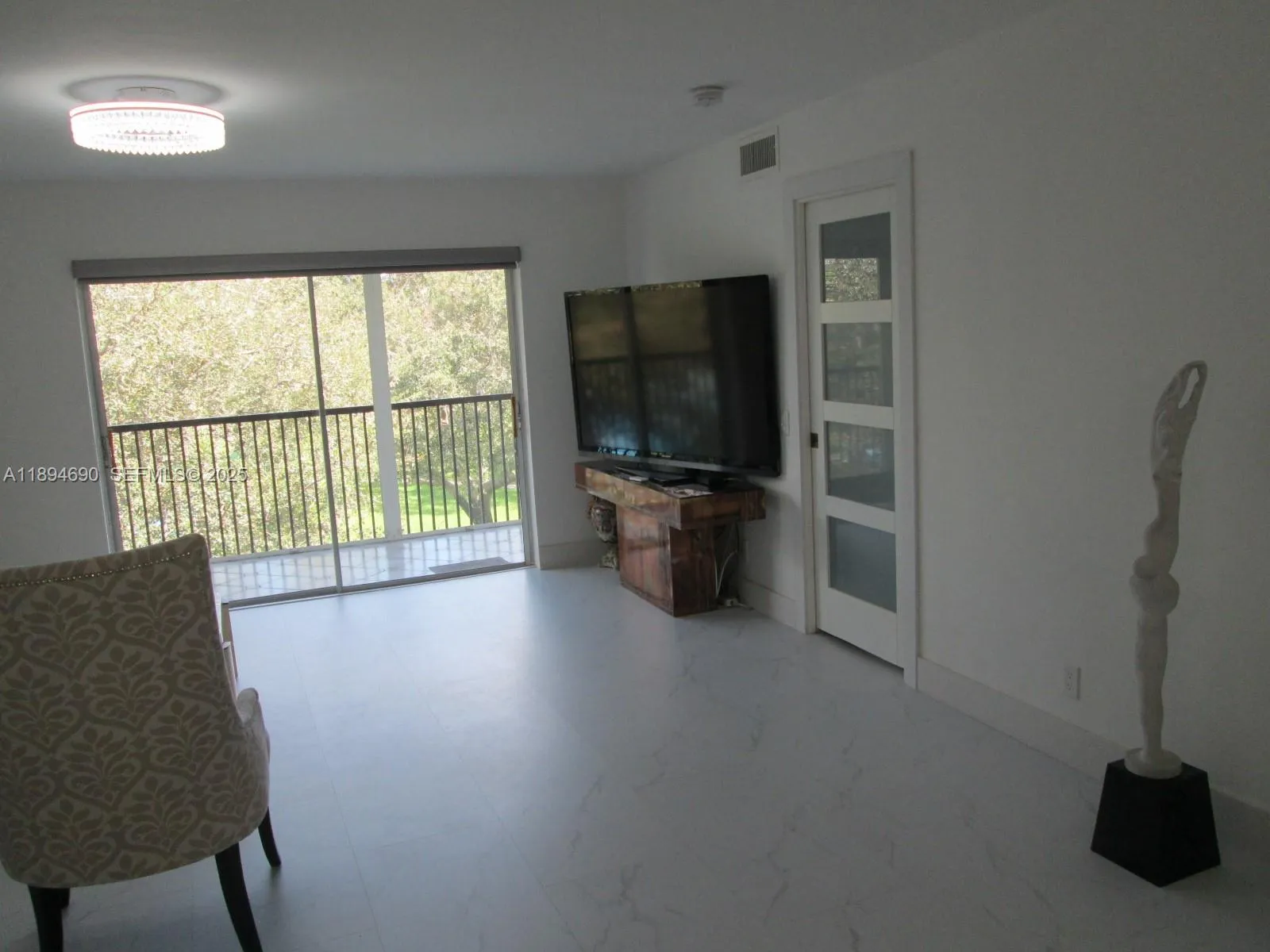 Part of room looking to balcony and outside