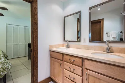 En suite full bath with two sinks adjoining bedrooms 3, and 4