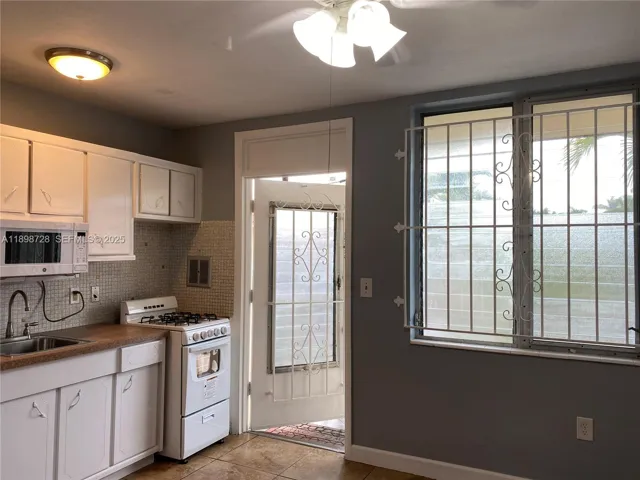 View of the kitchen- living room area, with the front door in the center.