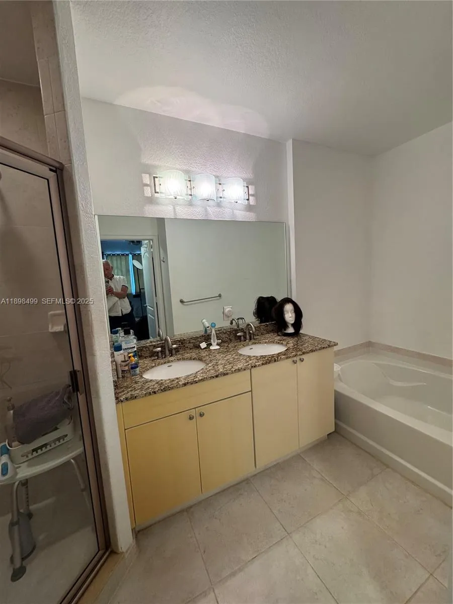 Master Bathroom with two sinks, tub and separate shower