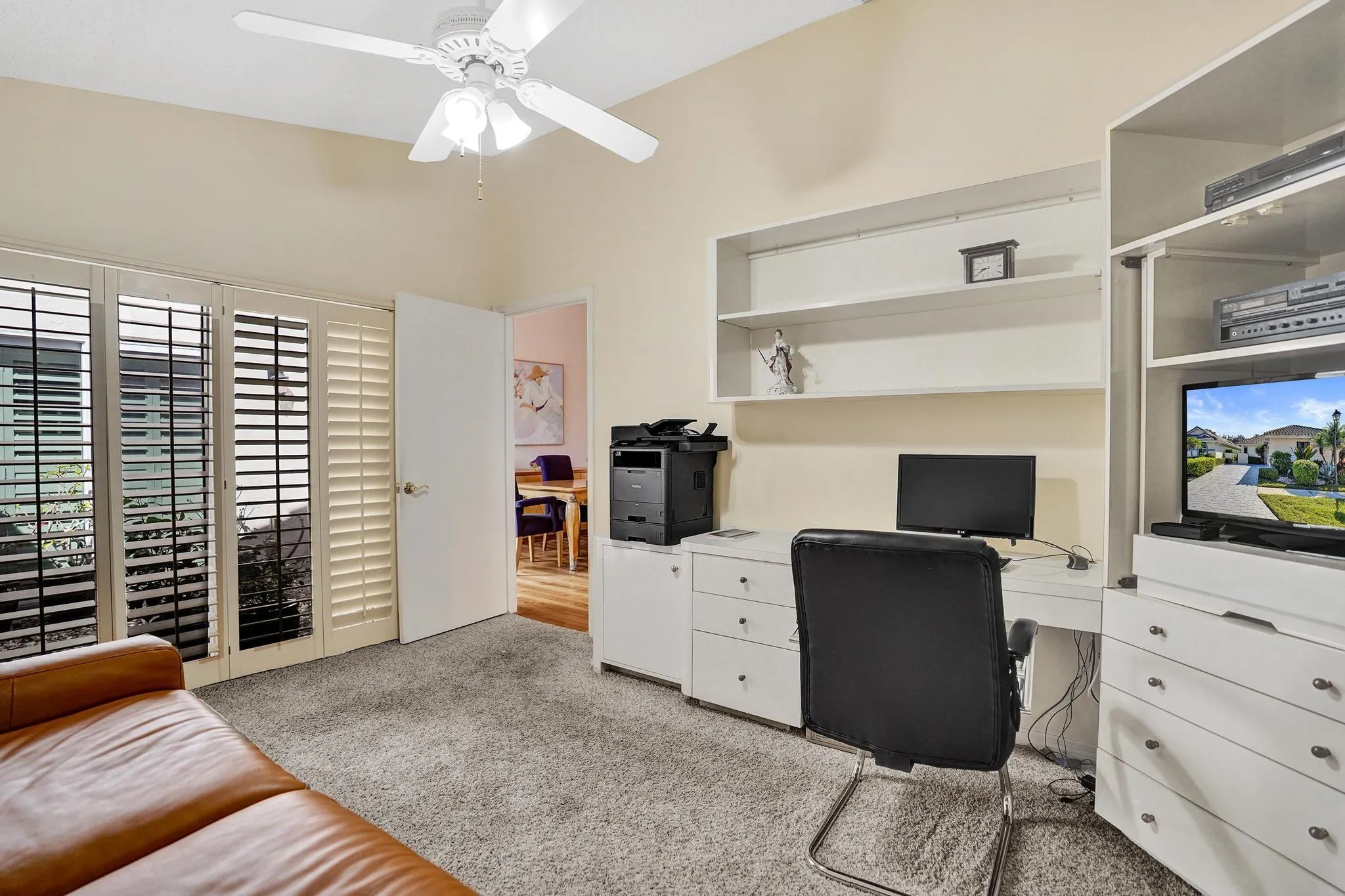 Located in the center of the residence. Built in wall unit stays. Paddle Fan and Plantation Shutters with impact sliding glass doors to Atrium