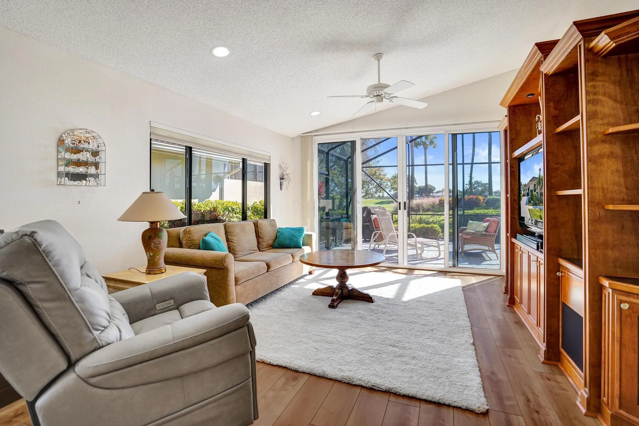 Primary living space with view of golf and patio area