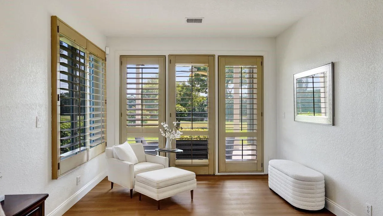 Plantation shutters on sliding doors have been replaced by brand new impact glass doors with brand new automated shades.