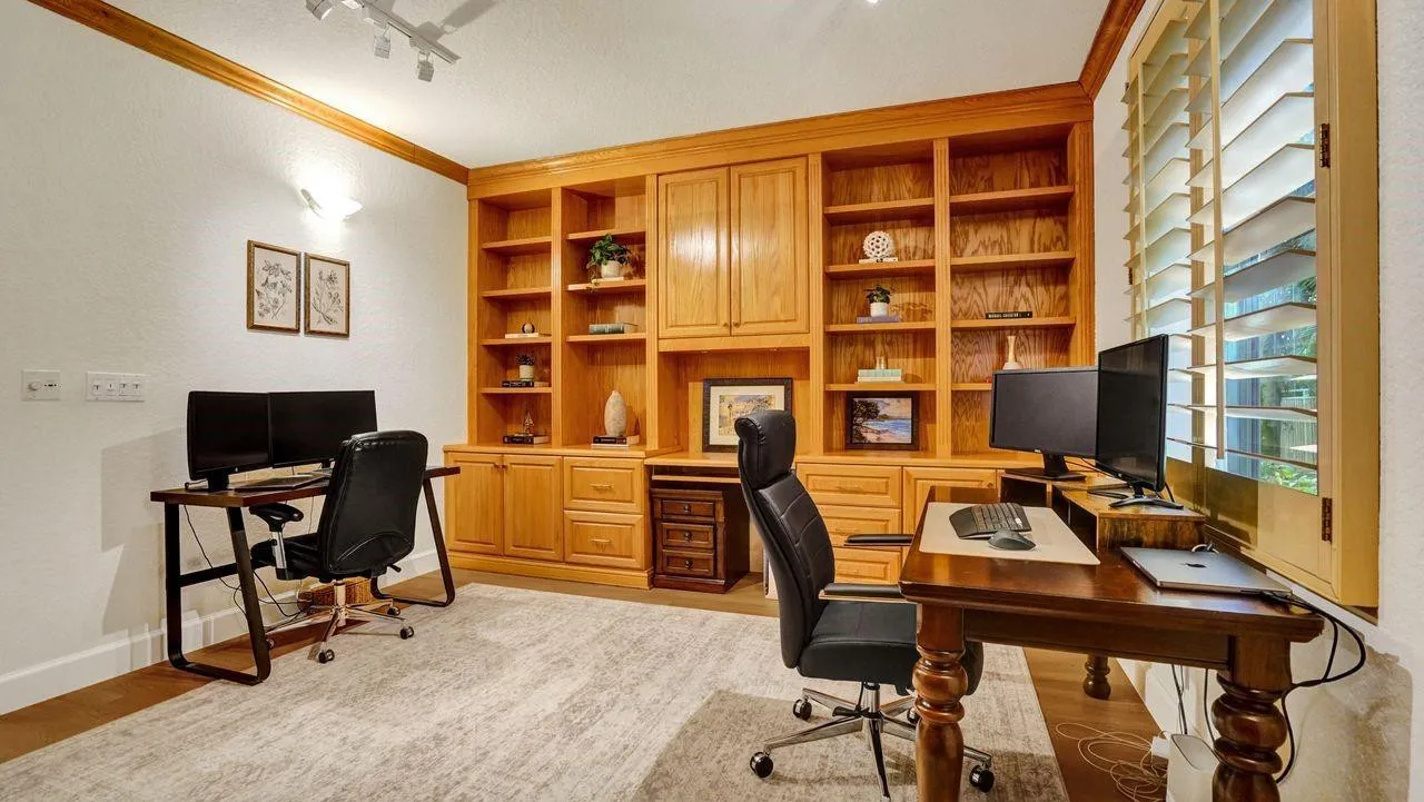 4th Bedroom is outfitted with custom solid wood cabinetry, crown molding, plantation shutters and walk-in closet.