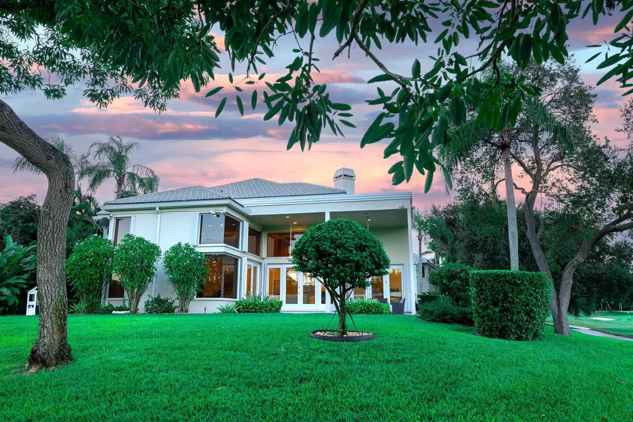 $25K worth of recent landscaping improvements throughout the property, the backyard is flanked with gorgeous trees, and overlooks meandering golf and lake views.