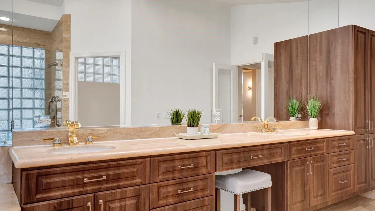 Beautiful wood cabinetry with custom drawers, marble counters, linen tower, high ceilings.