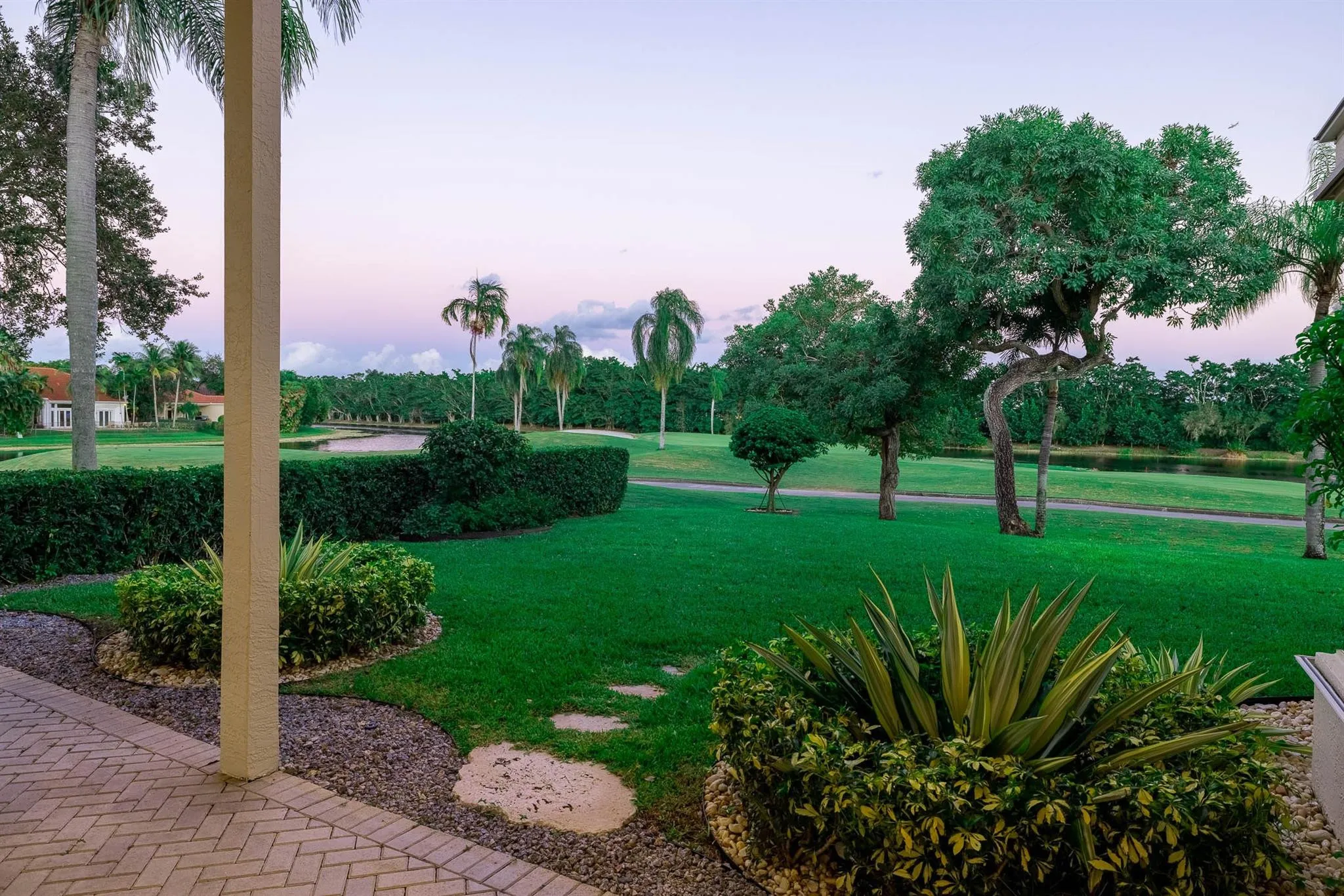 Expansive lawn, beyond which lies the 16th and 17th holes of the Tours Course of Weston Hills, plus meandering lake wraps around the course as well!