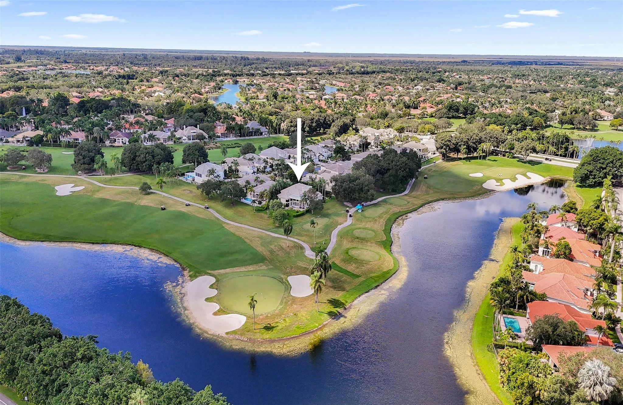 Situated on one of the most premier lots in Weston Hills, with panoramic wrap-around golf and lake!