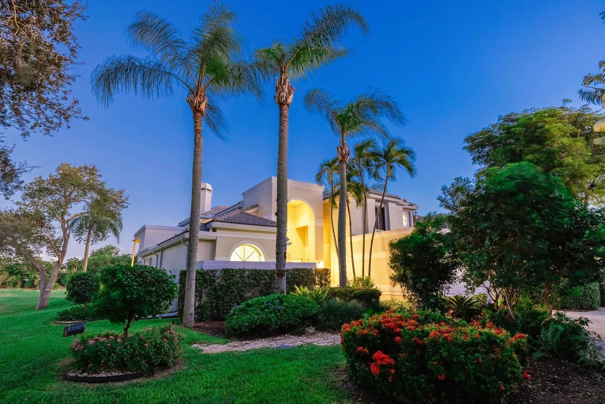 Wrap-around, manicured landscaping frames the entire property.