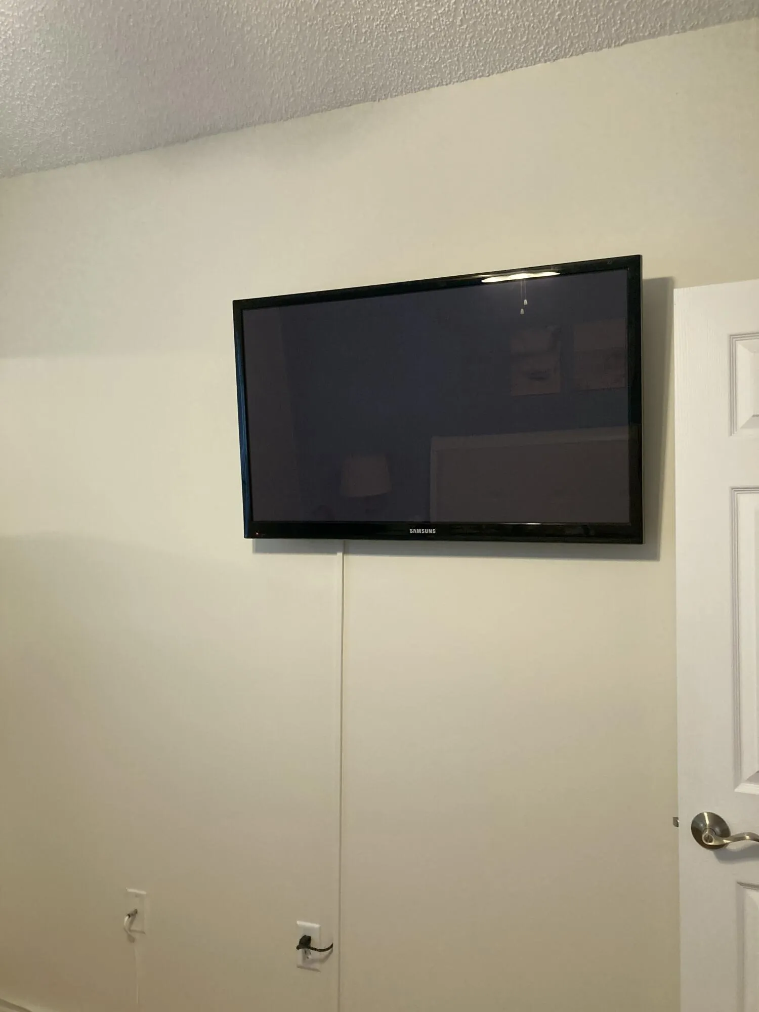 TV Mounted in Primary Bedroom