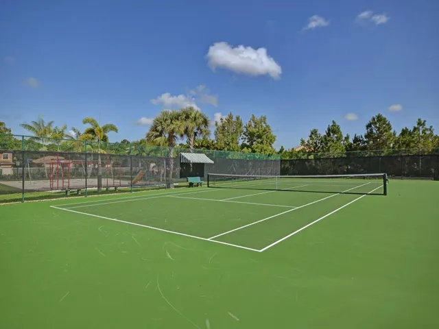Tennis court featuring community basketball court