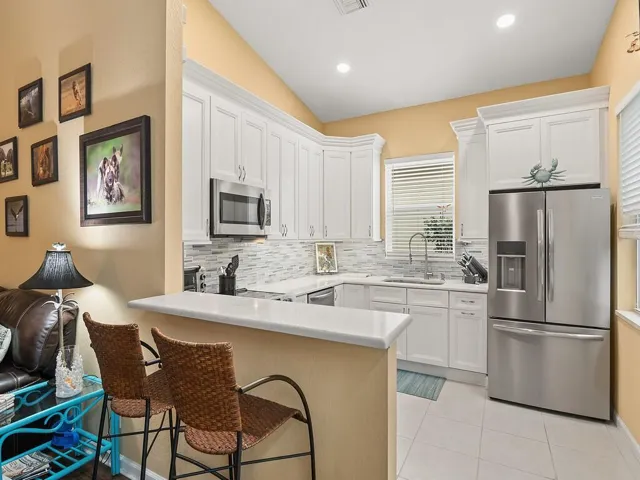 Updated Kitchen featuring stainless steel appliances, white cabinets, pantry