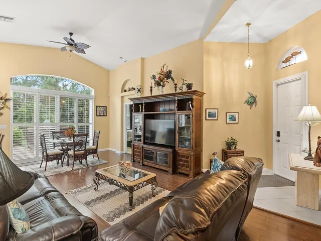 Living area featuring laminate floors and vaulted ceiling