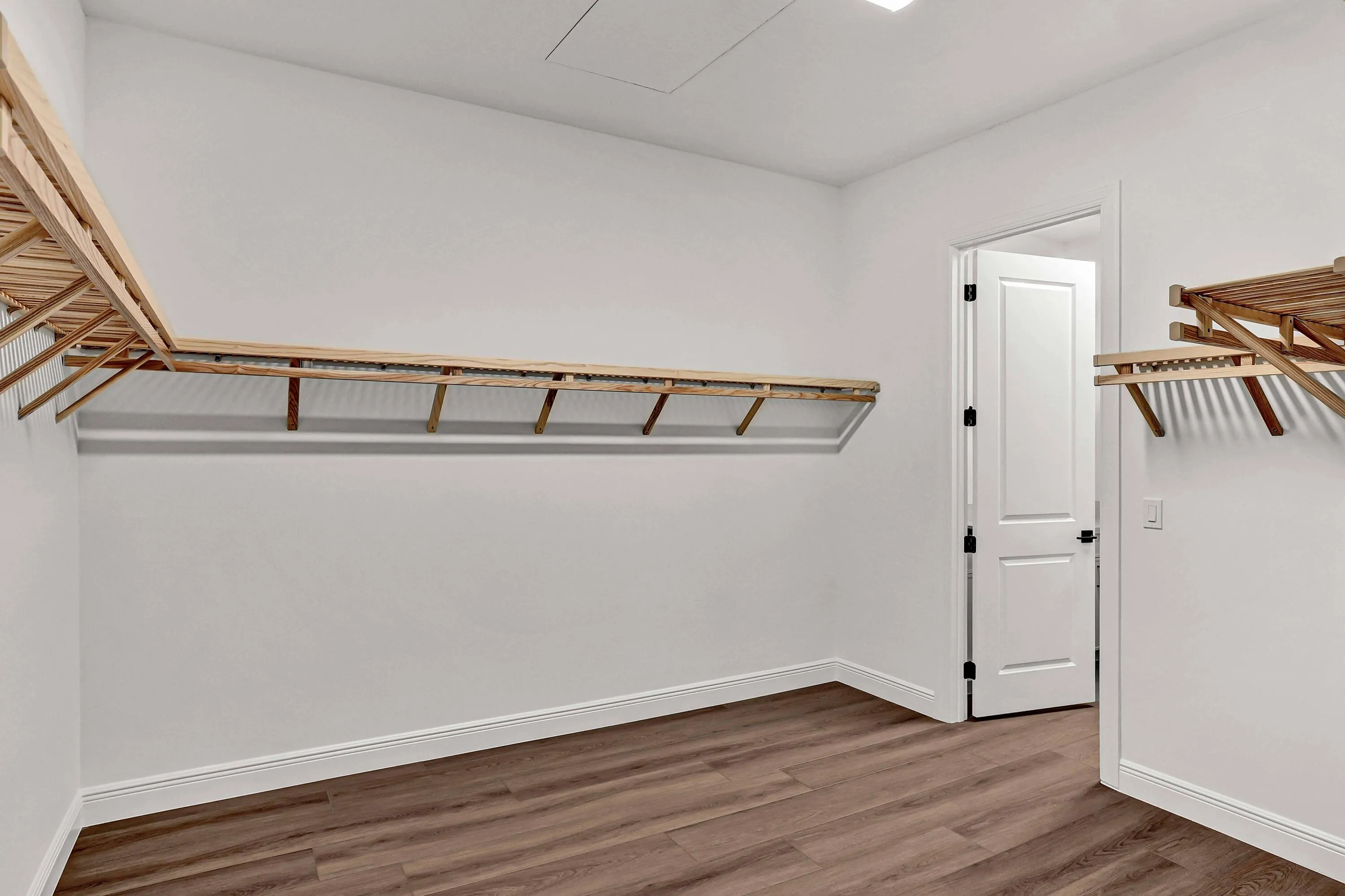 Primary Closet with Door leading into Laundry Room