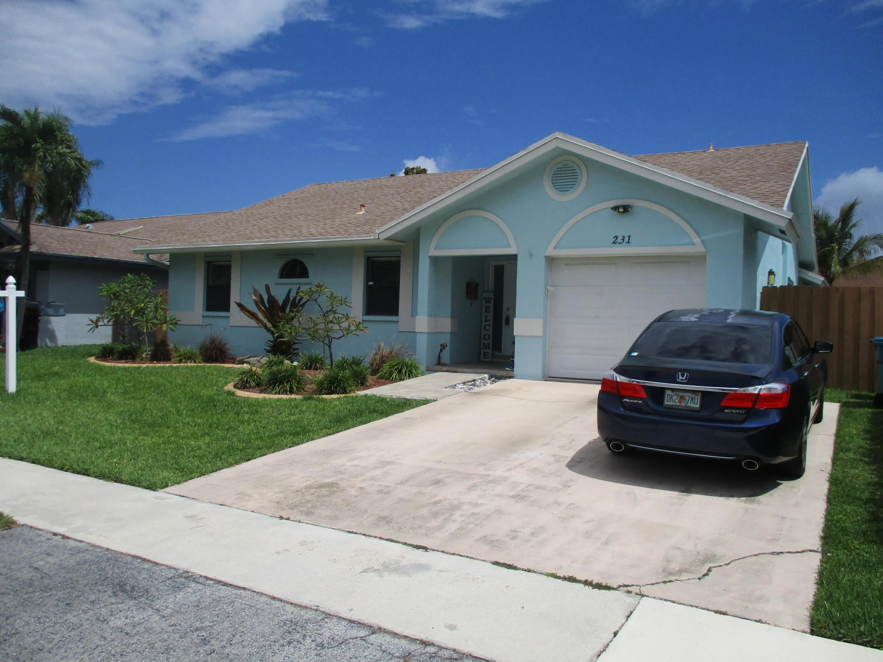 concrete driveway and a one car garage