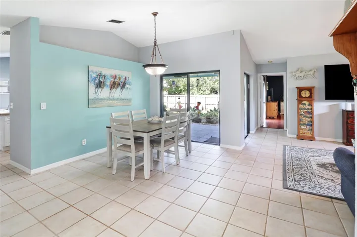 Valuted ceilings, cheerful coastal blue wall with sliding doors to your massive yard.