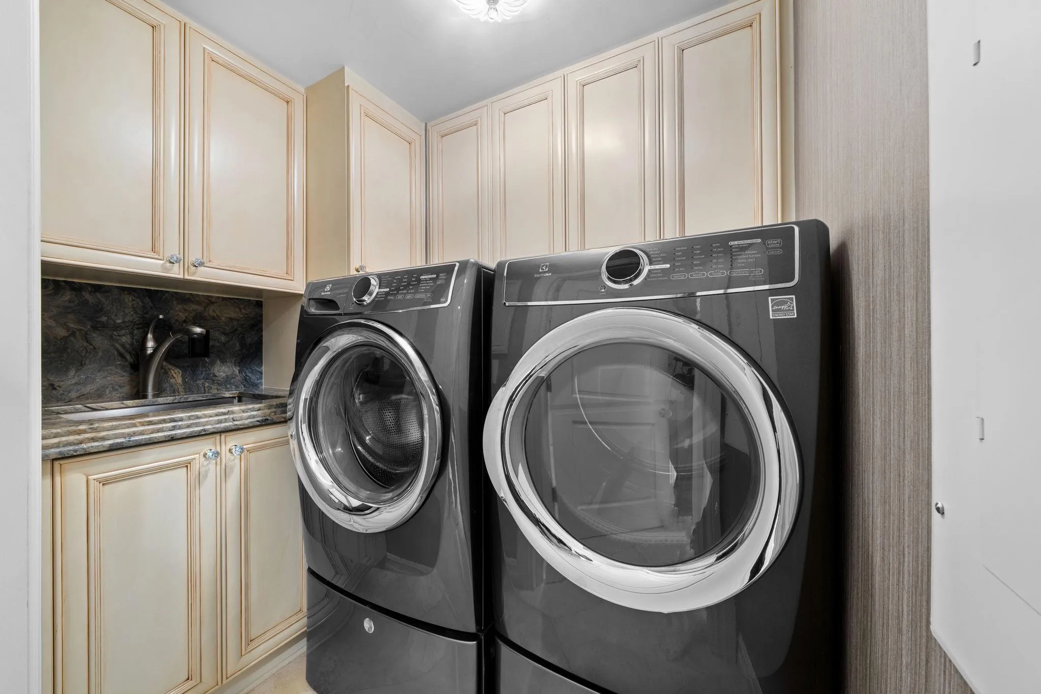 Separate Laundry Room with Electrolux Washer & Dryer with extra storage