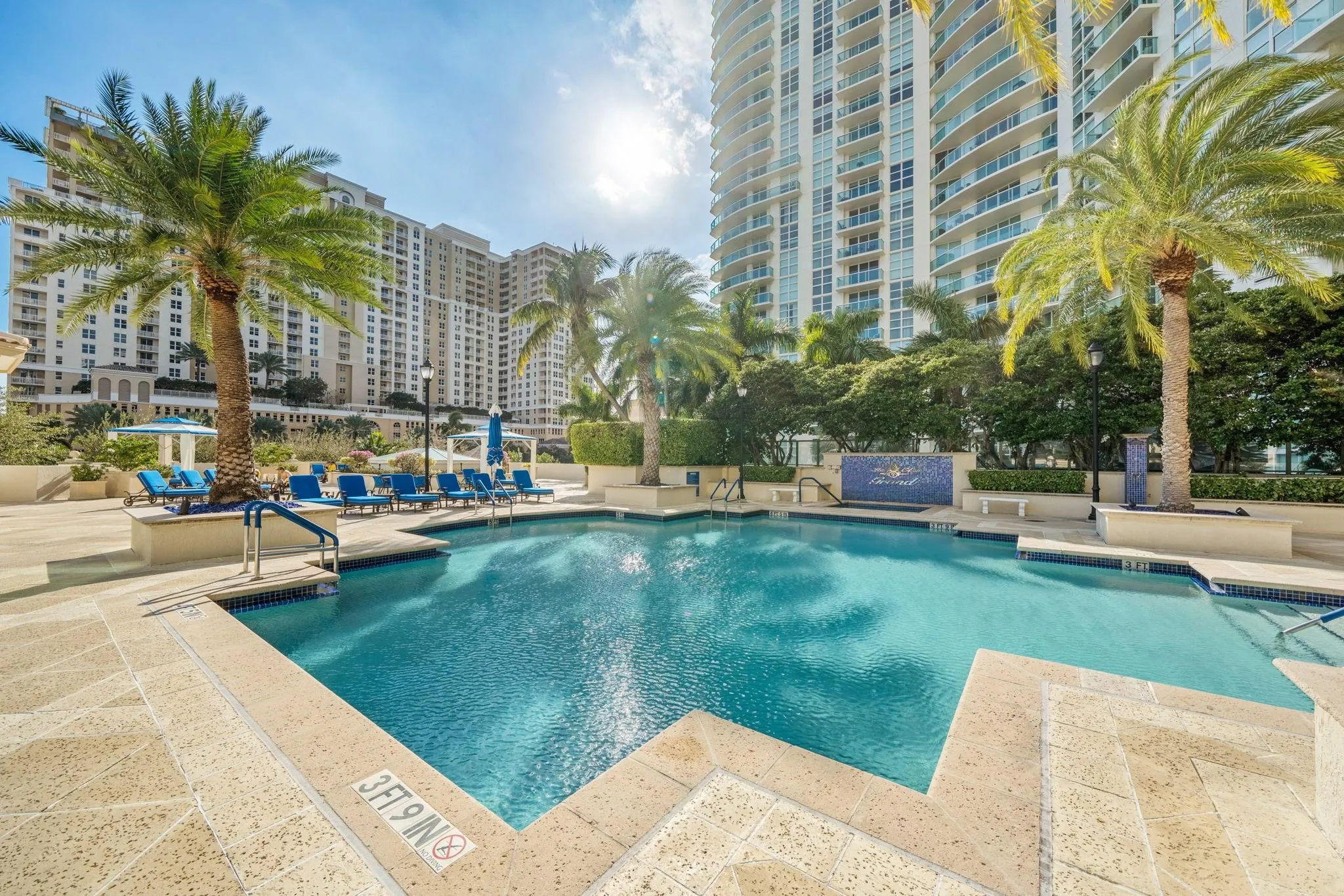 Tropical pool deck with jacuzzi, summer kitchen and barbeque grills