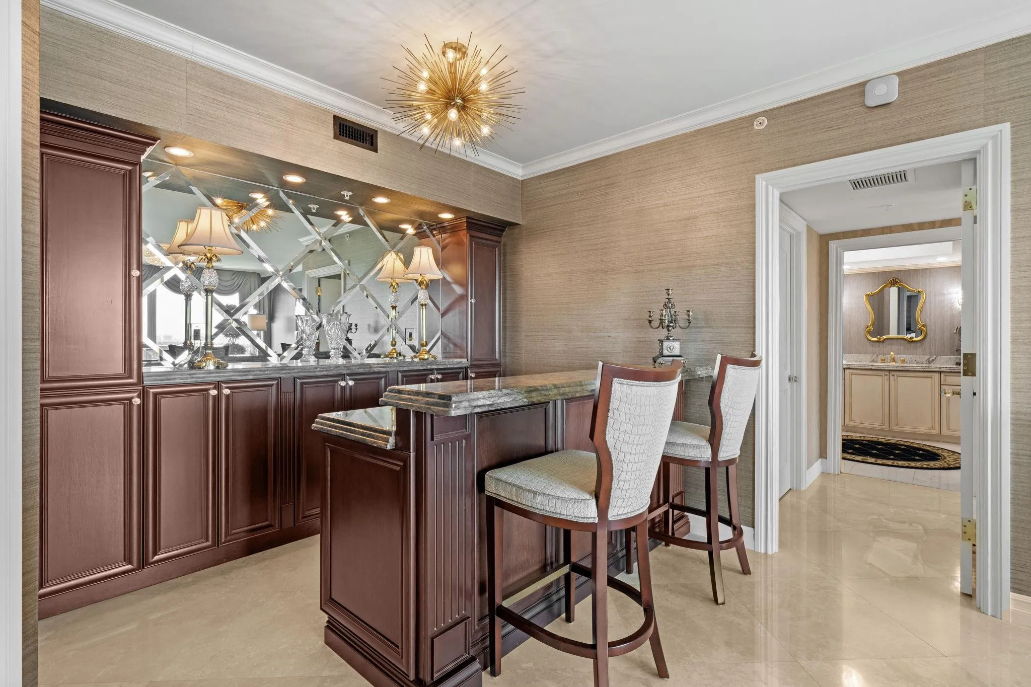 Custom Built-in bar with refrigerator and wine cooler. Plenty of storage and seating