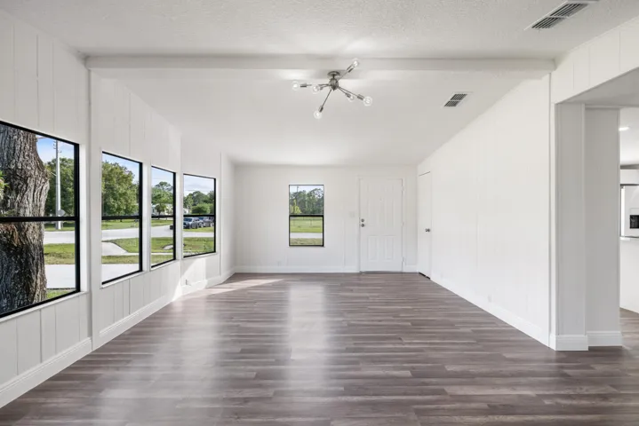 Empty room featuring dark wood-style flooring