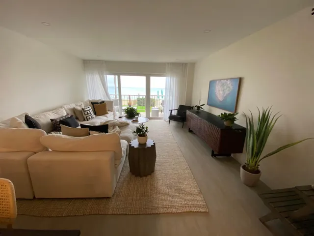Enjoy tropical blue ocean views from gorgeous couch and dining and kitchen areas.