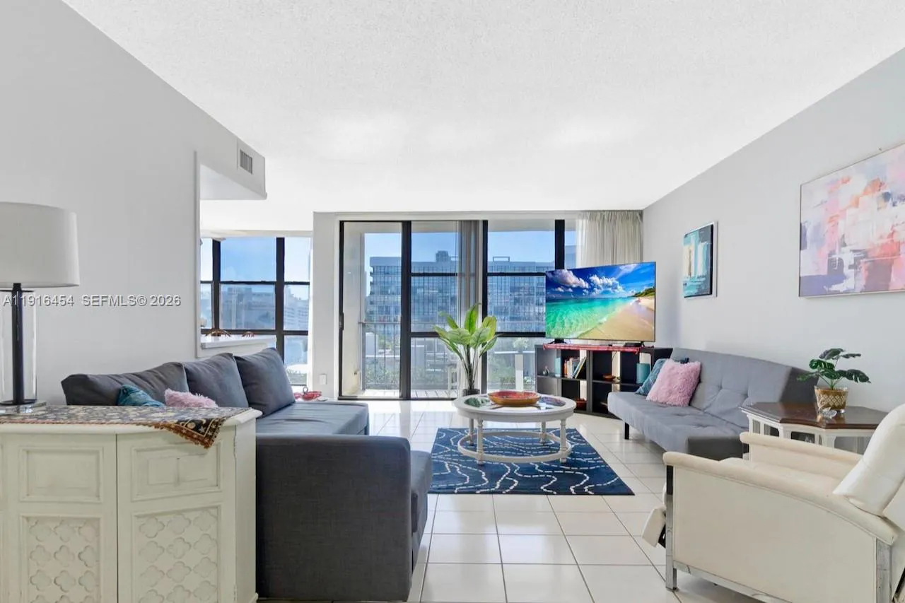 Spacious living room with lots of light and tile flooring. - Oceanview Park Condominium, Three Islands, Hallandale Beach, FL 33009. 1000 Parkview Drive, Unit #518.