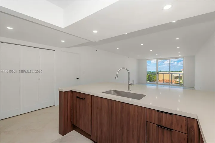 open kitchen next to large double closet/pantry