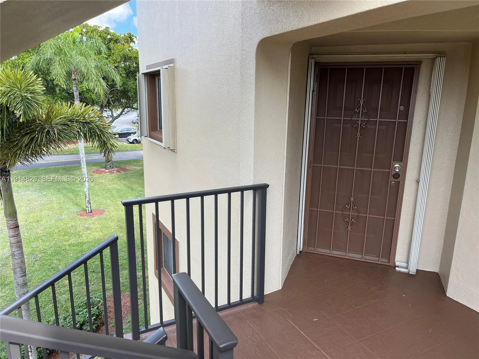 front door , green area to the north , accordion shutters and storm door