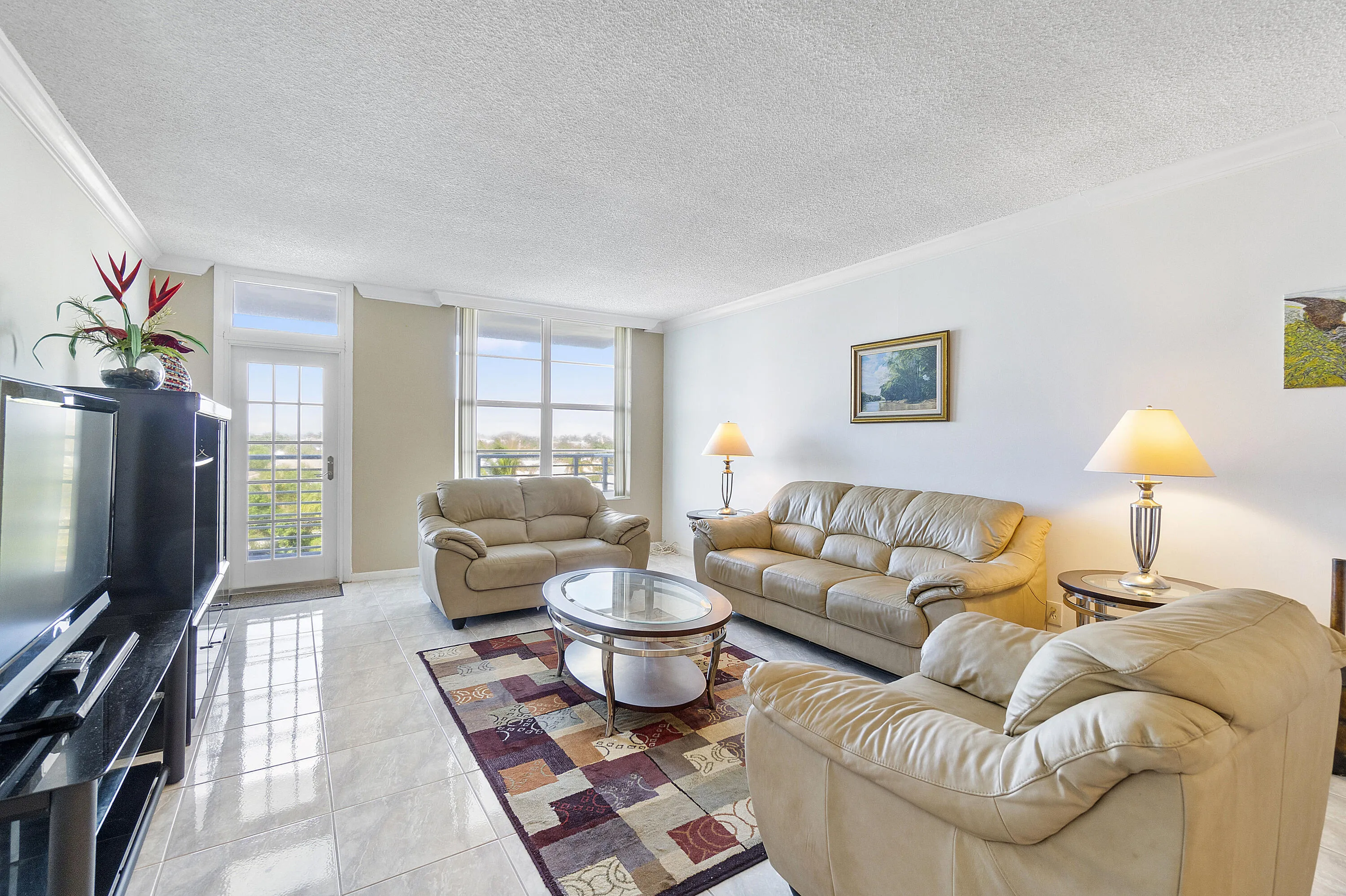 Open floor plan, 9 ft ceiling with crown molding, hurricane impact windows and door to your balcony