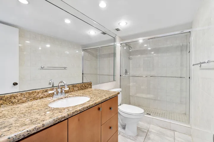 Granite countertops, walk in shower with glass doors