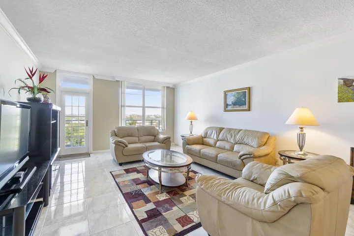 Open floor plan, 9 ft ceiling with crown molding, hurricane impact windows and door to your balcony