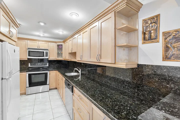 Wood cabinetry, granite counter-tops, custom lighting