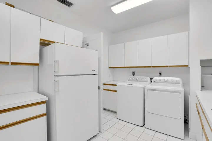 Laundry room with refrigerator
