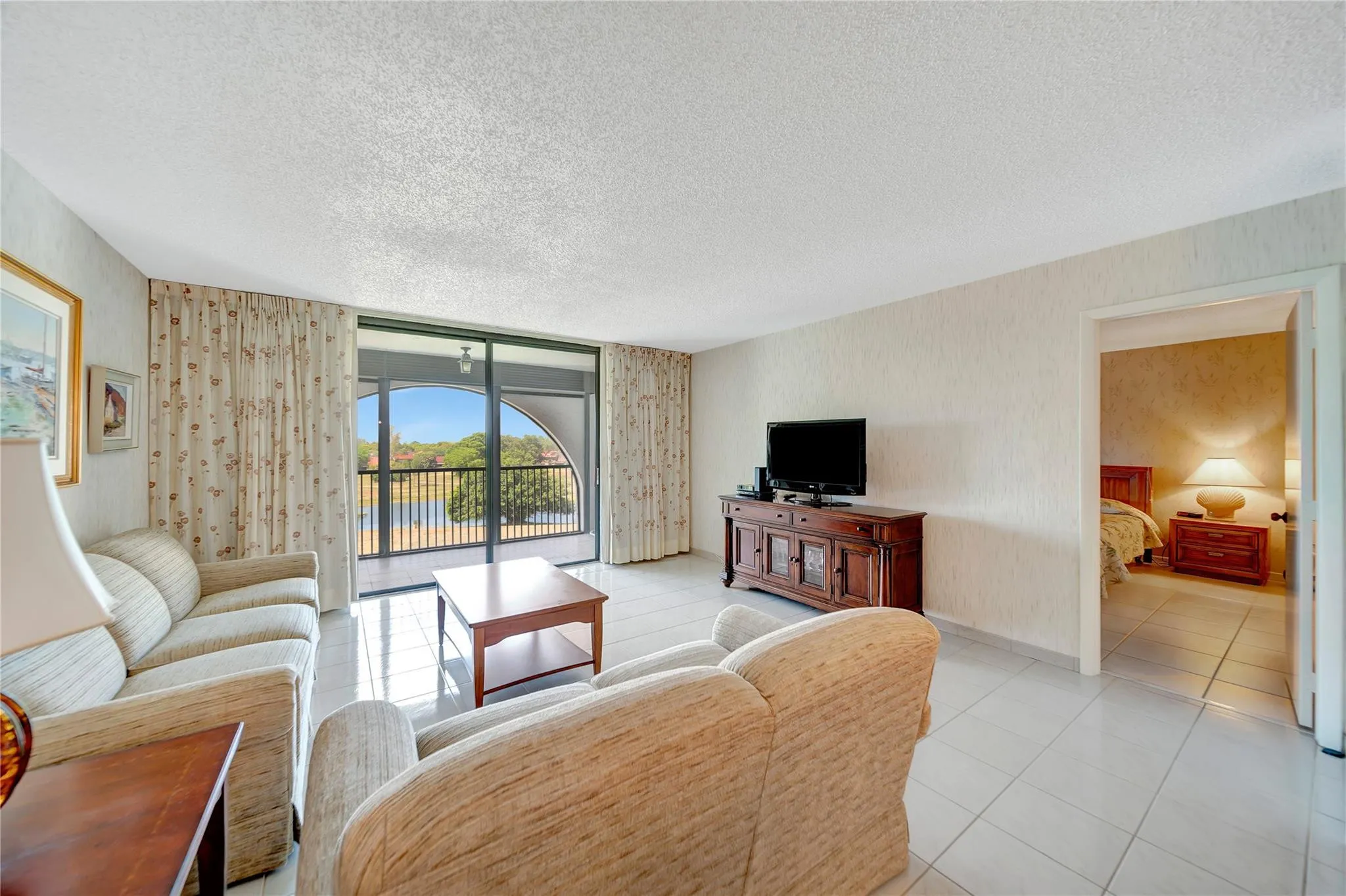 Living Room; Patio Doors To Screened Balcony; Doorway to Master Bedroom on Right