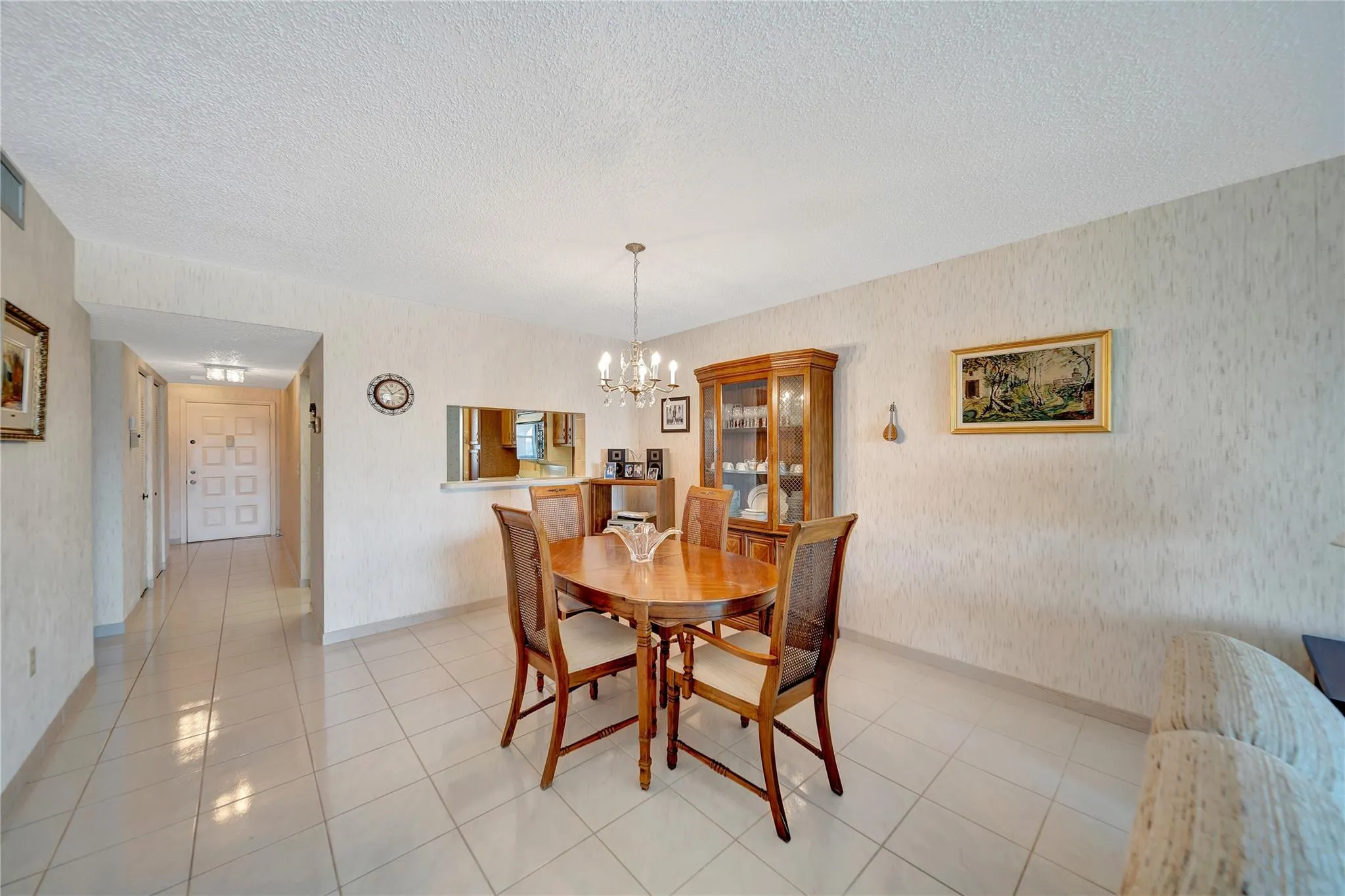Dining Room with Pass-Through to Kitchen; Front Door Entrance and Hallway