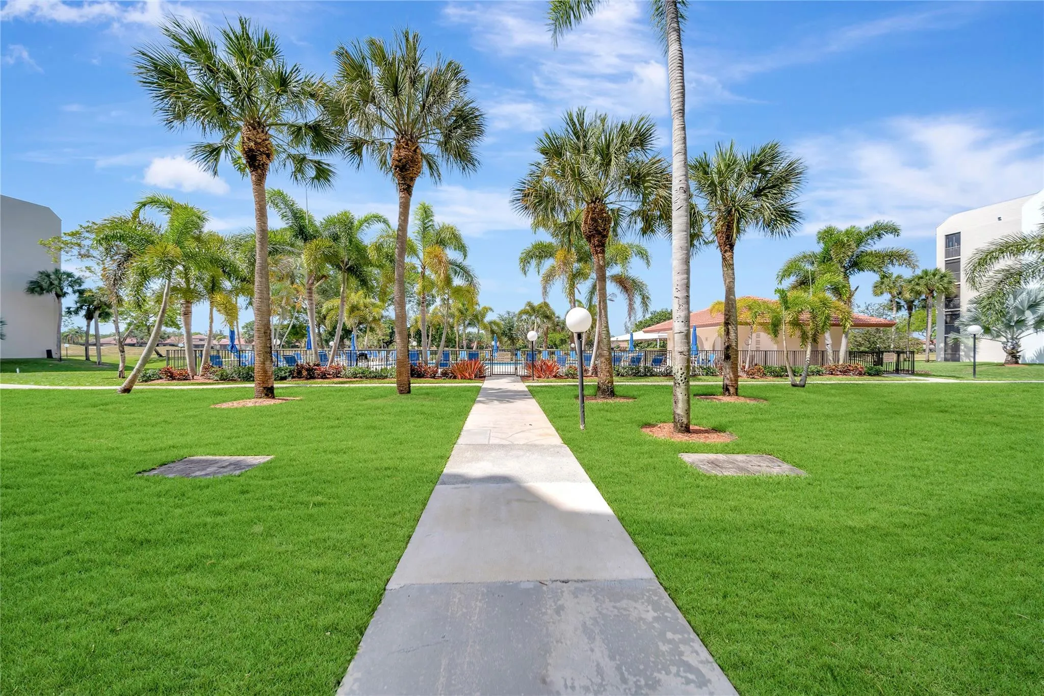 Beautifully Manicured Landscaping and Sidewalk to Pool
