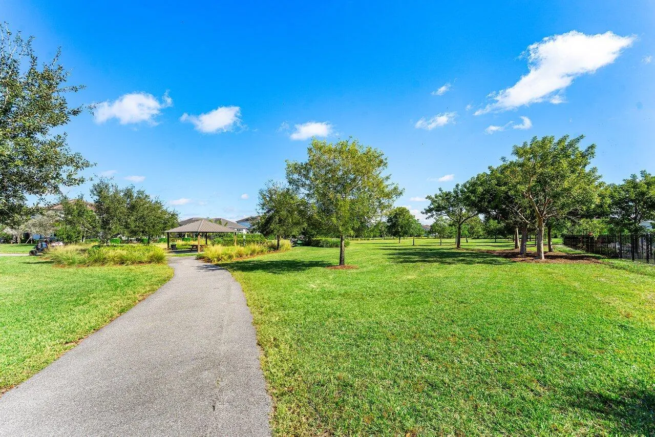 Lush corner-lot walkway with trees